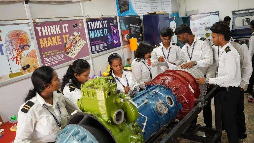 Students working on jet engine turbine